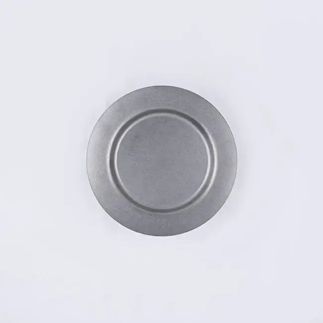 Stainless steel vintage round plate with minimalist design, durable and versatile for various uses.