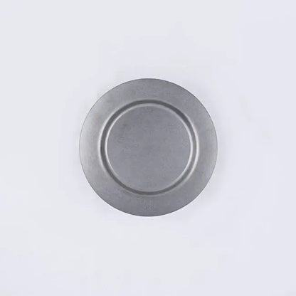 Stainless steel vintage round plate with minimalist design, durable and versatile for various uses.