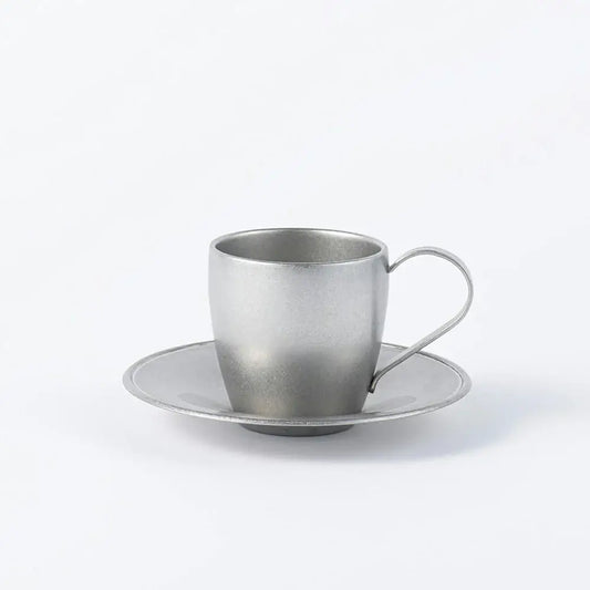 Stainless steel vintage cup and saucer set, featuring a sleek silver finish, made in Japan, perfect for elegant tea or coffee serving.