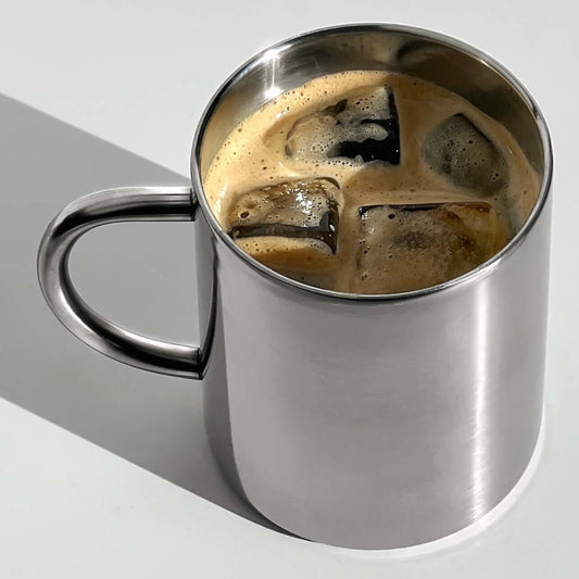 Double-layer glossy stainless steel cup with iced coffee, showcasing modern elegance and temperature control features.