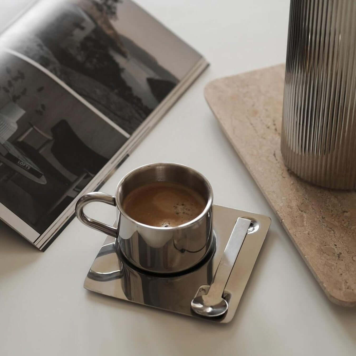 Sleek Venice Mirror Cup Set with saucers showcased on minimalist shelf with modern glassware.