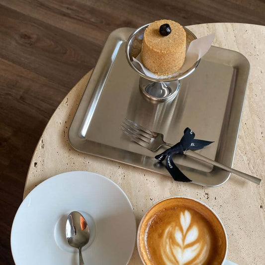 Urban Chic stainless steel serving trays displaying desserts and beverages on a minimalist table setting.