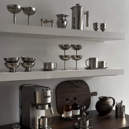 Stainless steel ice cream cups, one displayed with a perfume bottle, showcasing minimalist elegance and premium design.