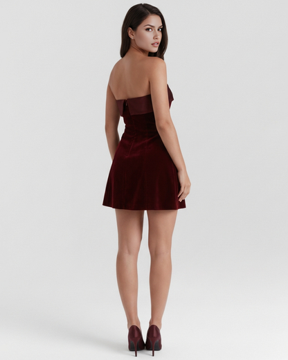 Woman wearing a burgundy dress on a white background
