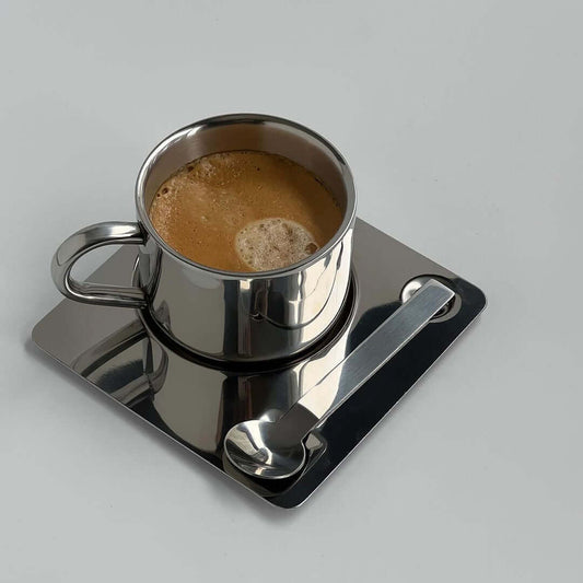 Venice Mirror Cup Set with saucer and spoon on table, showcasing polished mirror finish and modern elegance.